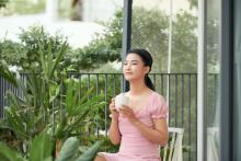 young-asian-woman-is-having-coffee-balcony